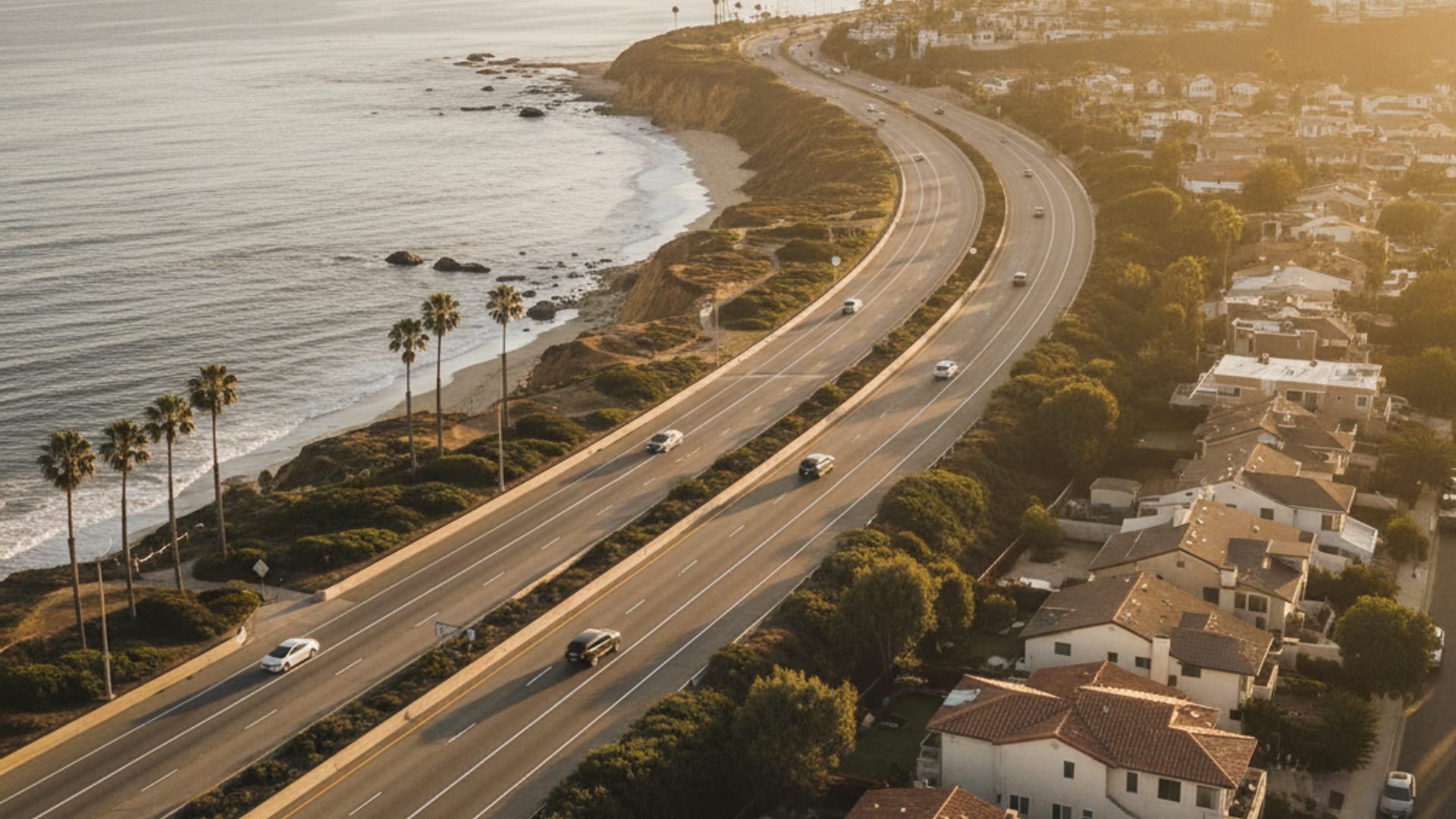 Aerial view of Los Angeles County freeway network at golden hour showing coastal Oceanside through inland Escondido to east-county Julian